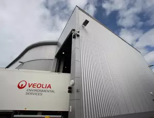 Photo shows lorry and a building, the lorry says Veolia Environmental Services. 
