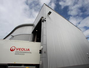 Photo shows lorry and a building, the lorry says Veolia Environmental Services. 
