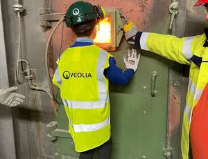 Photo shows a student looking into the furnace